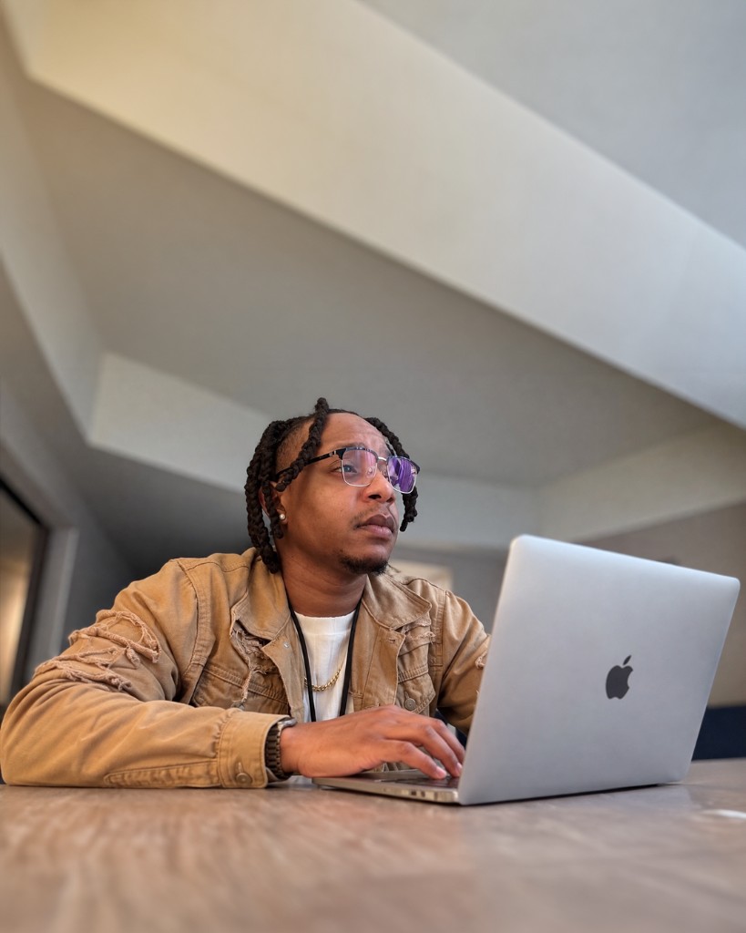 Marcus McGhee, founder of Heartwork Design Co., working at his laptop